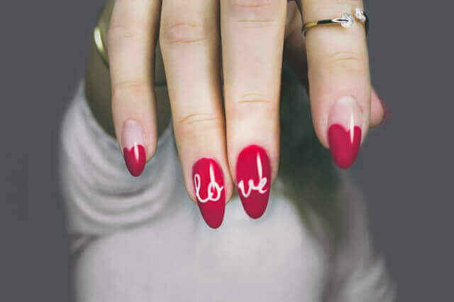 Hand with red nail design