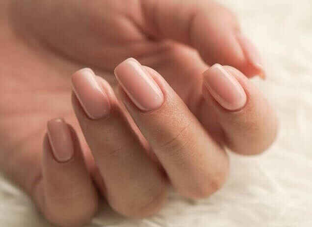 Hand with soft pink nails